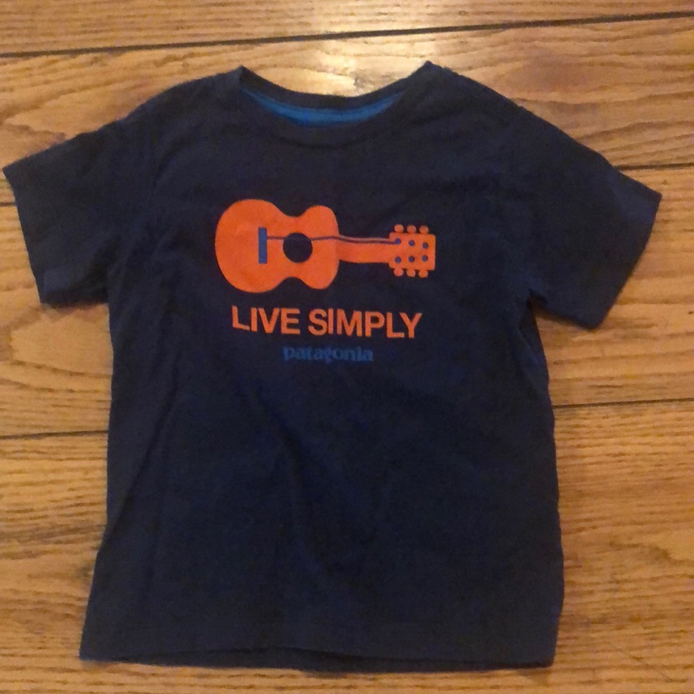 Patagonia Tshirt, says “Live Simply”.